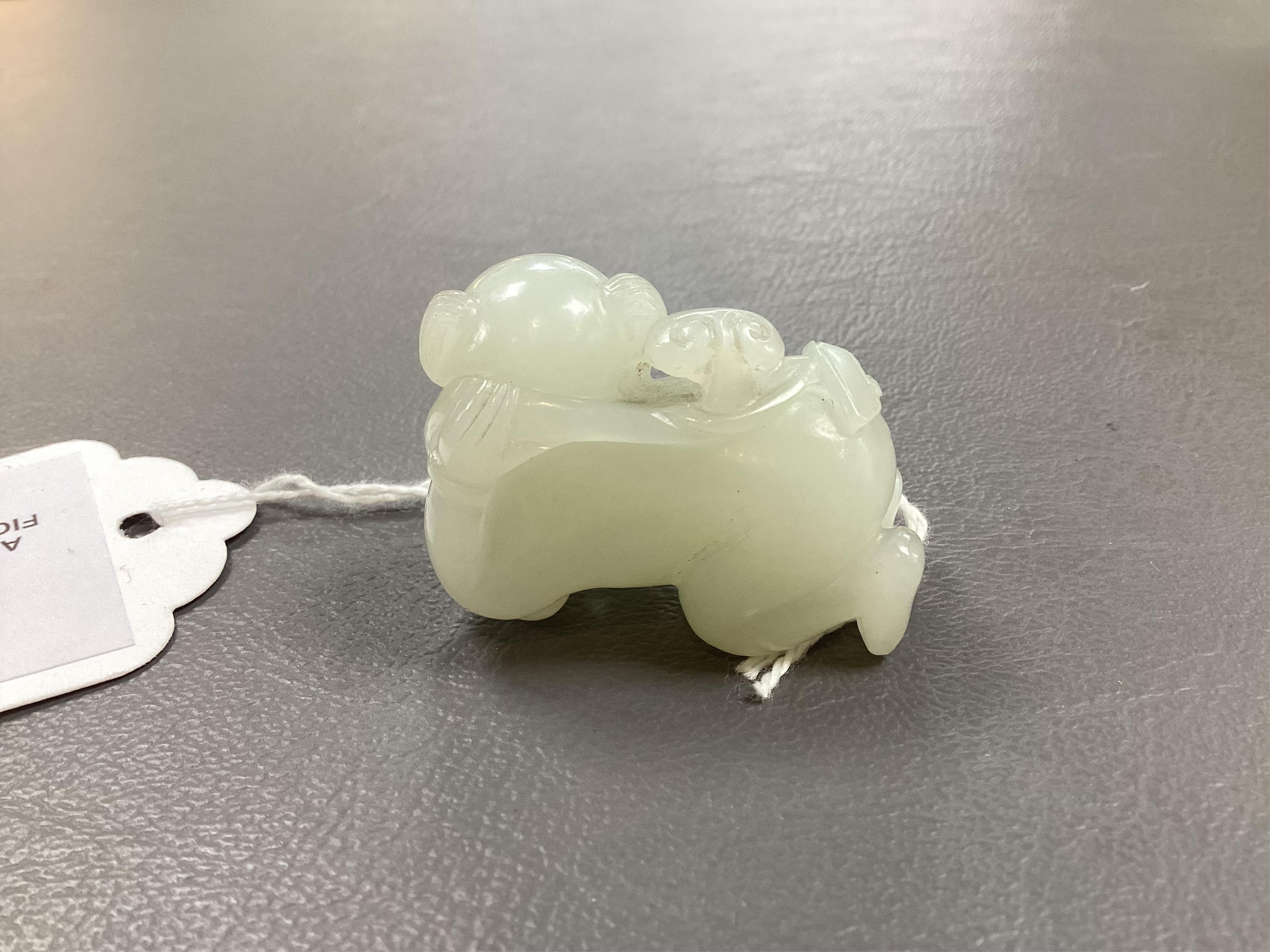 A Chinese white jade figure of a crouching boy, 19th/20th century